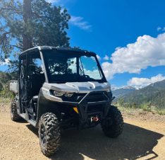 A four-wheel drive vehicle is parked on the dirt.